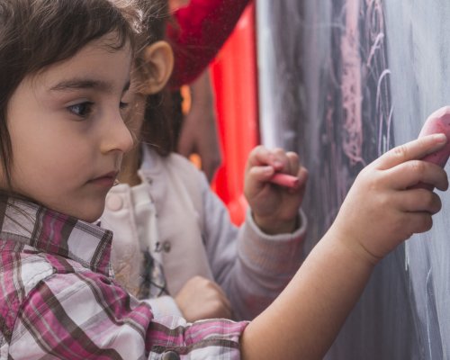 little-girl-drawing-blackboard